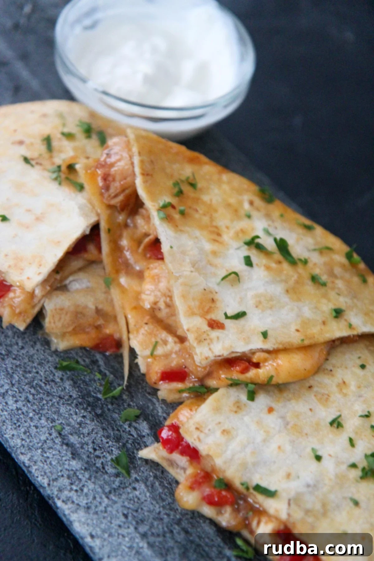 cheese and chicken quesadillas with sour cream on the side 