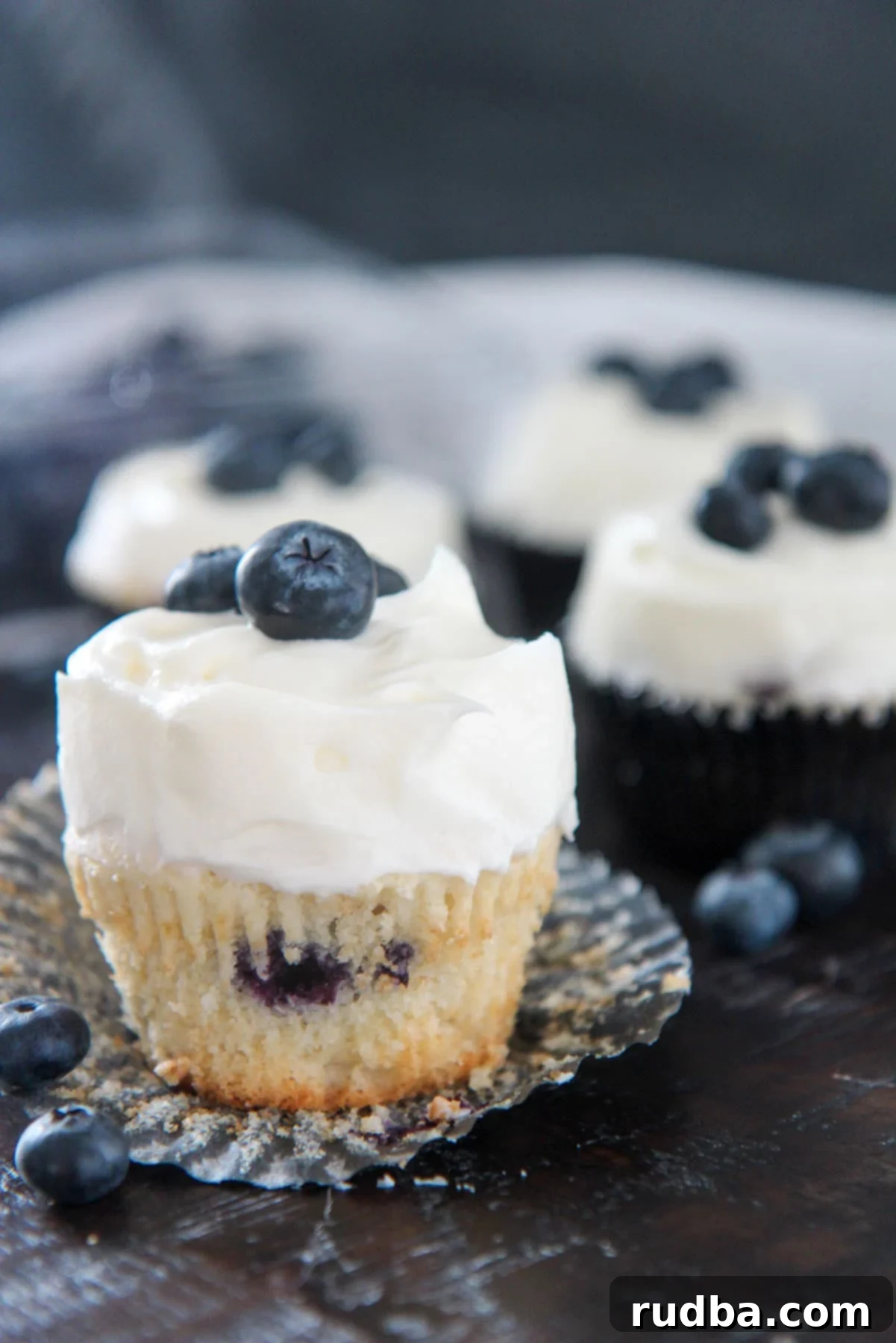 blueberry cupcake with cream cheese frosting up close 