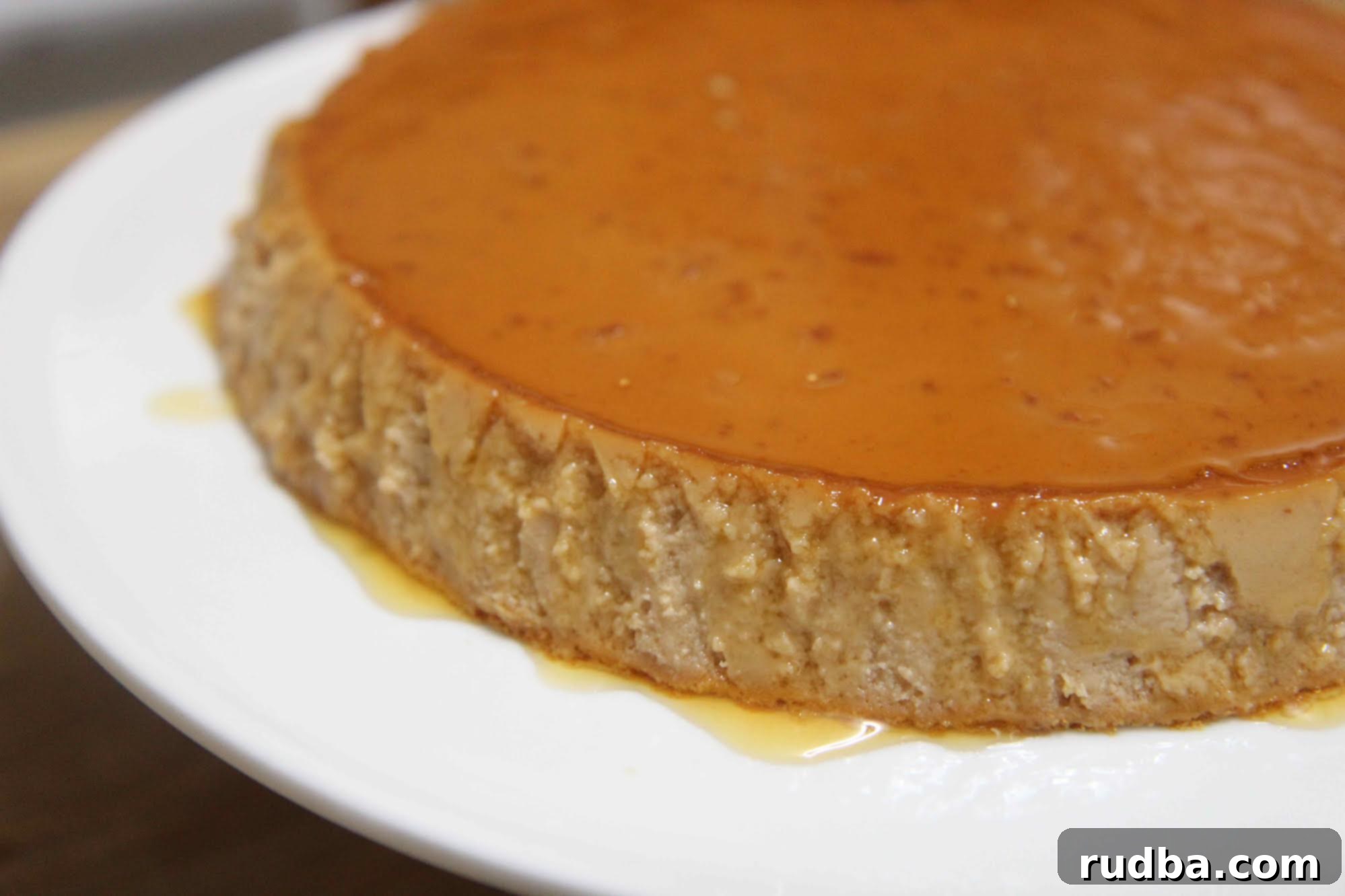 Close-up of the Guava Flan, showcasing its perfect creamy texture and glistening caramel topping.