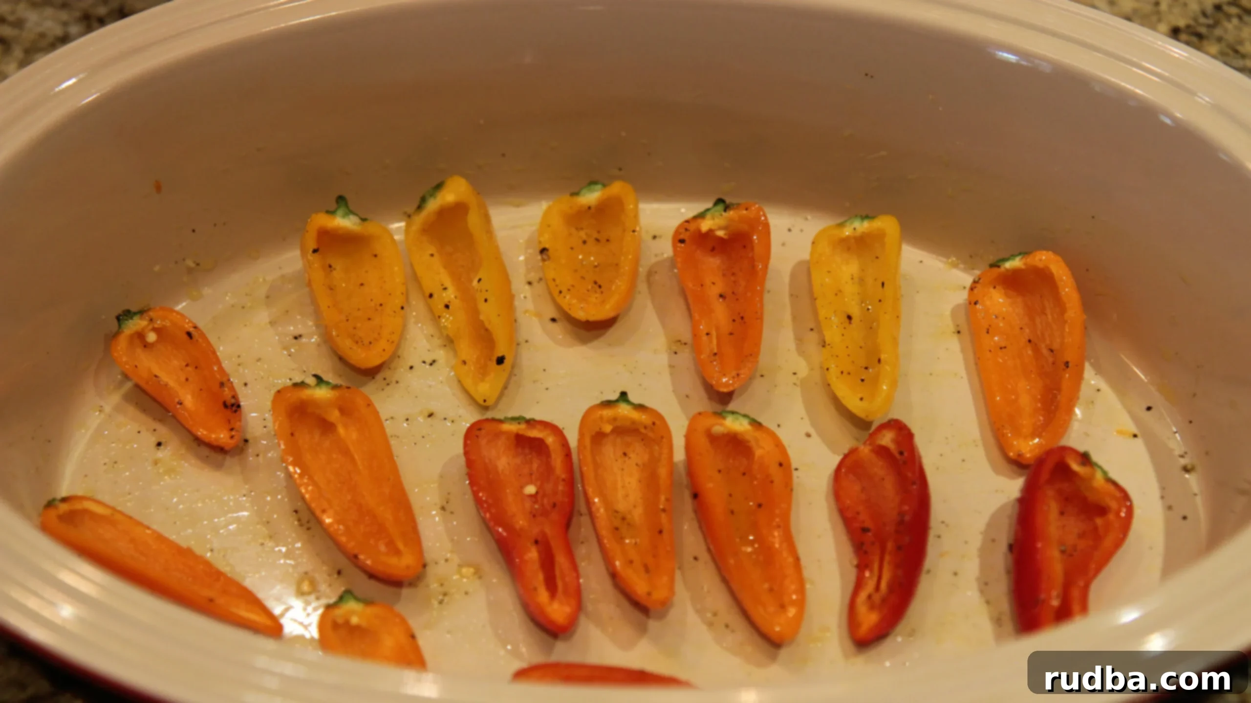Variety of mini bell peppers and cherry peppers laid out, perfect as small serving vessels for a delicious crab filling.