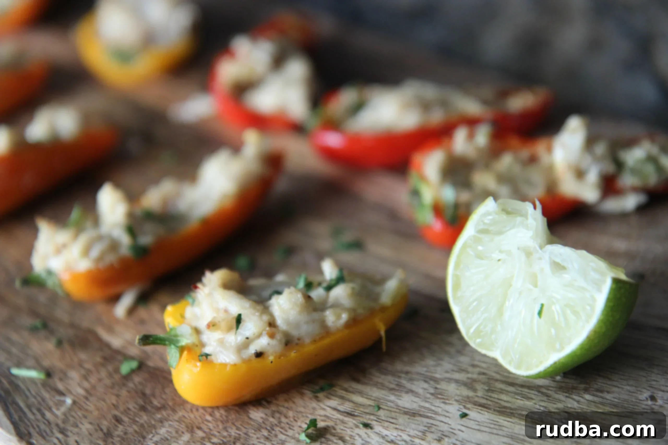 Close-up view of beautifully baked crab stuffed peppers, showcasing the generous crab filling and perfectly roasted pepper halves.