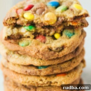 MM Cookies 5 eight m&m cookies stacked on top of each other. One cookie is cut in half.
