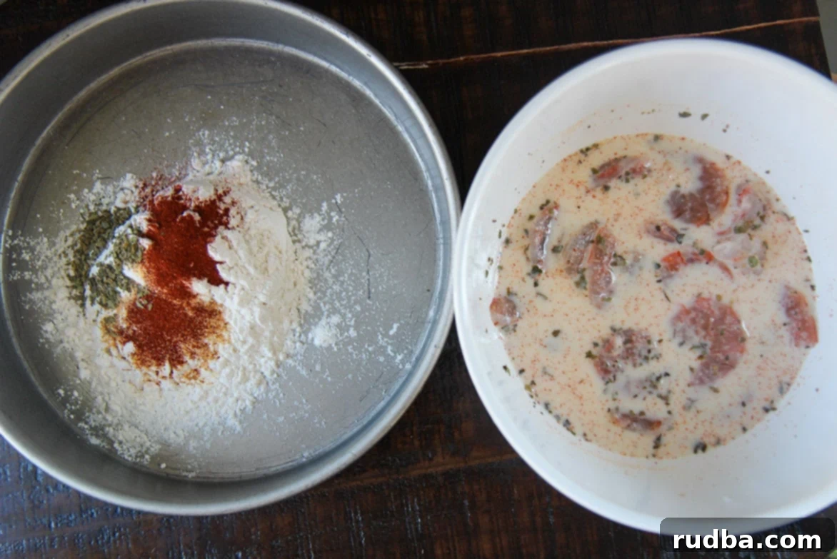 seasoned flour in a cake pan and seafood soaked in milk in a white bowl. 