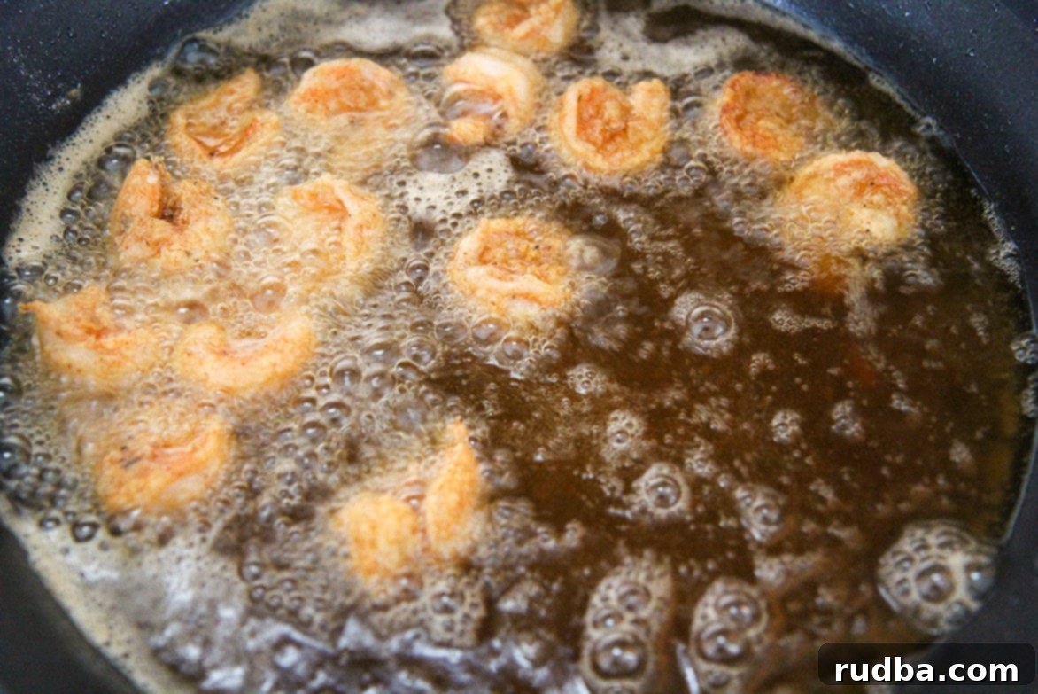 fried shrimp in an iron skillet with oil. 