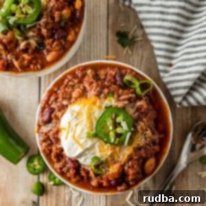 Delicious Crockpot beef chili in two small bowls, ready to be served.