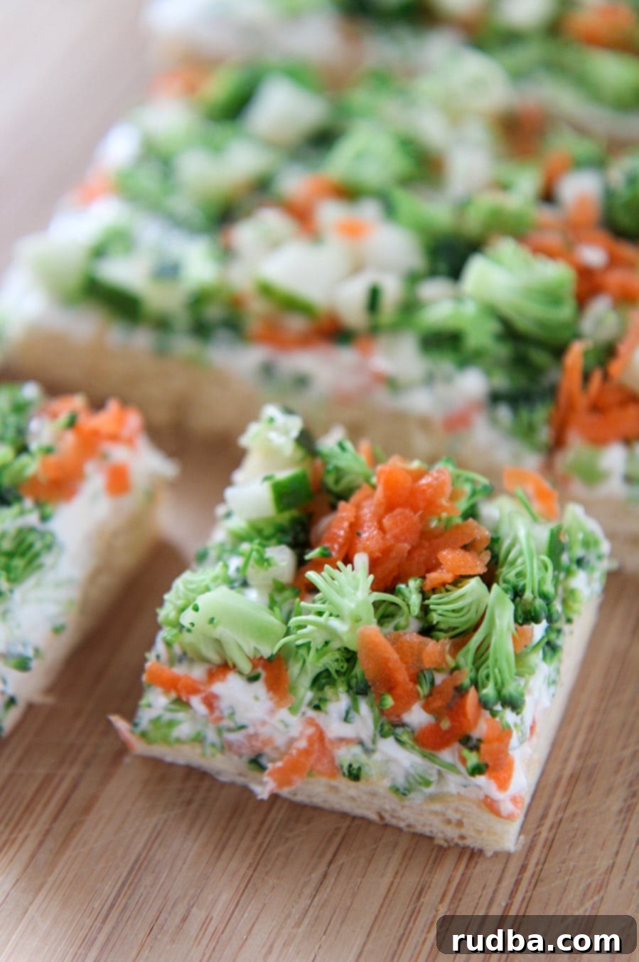 two squared vegetable bars on a wooden board