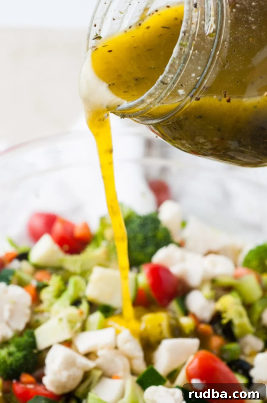 dressing poured over a bowl of vegetable salad.
