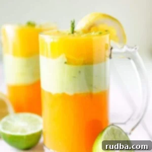 Ethiopian Spris Juice 7 two tall glasses filled with Ethiopian spris and limes on the side.
