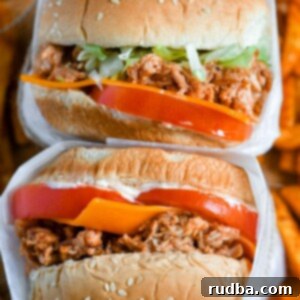Pulled Chicken Sandwiches 5 two chicken sandwiches stacked with sweet potato fries underneath.