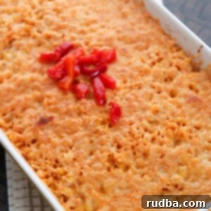 Imperial Rice: A Regal Feast 6 arroz imperial in a yellow casserole dish with melted yellow cheese and red peppers on the center.