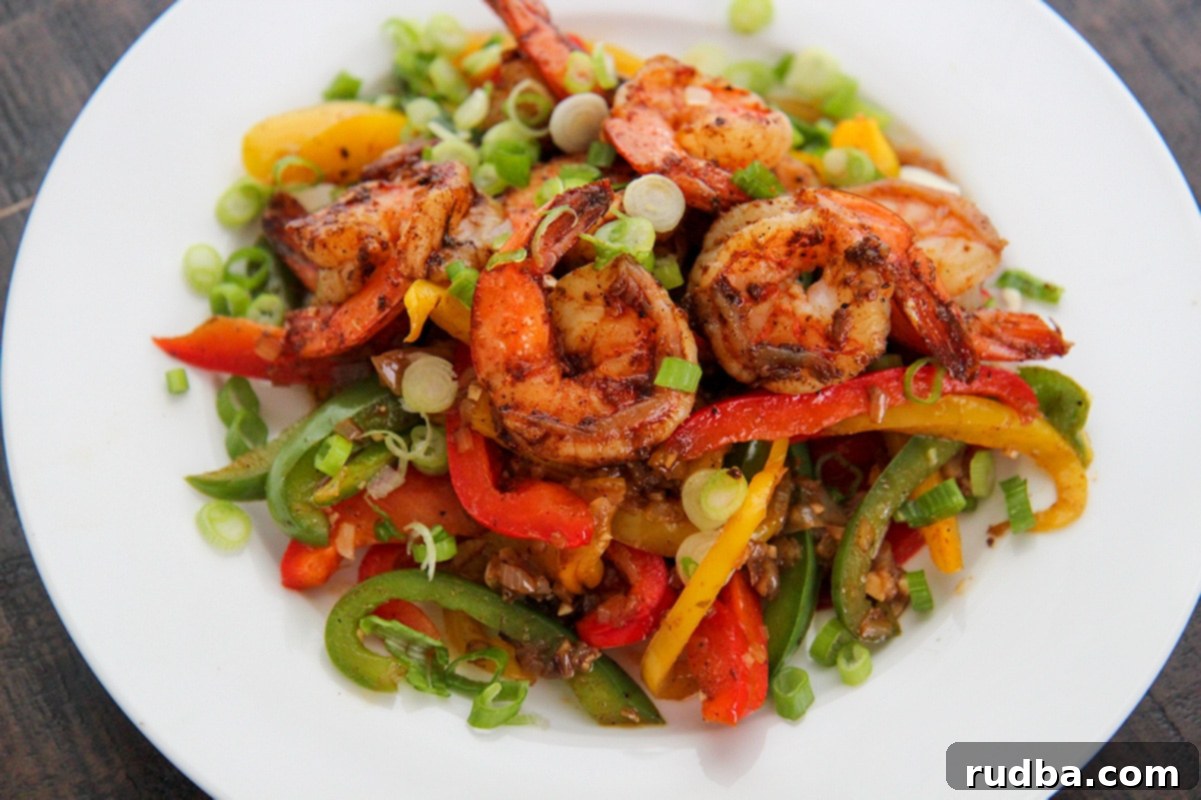 shrimp and veggies on a white plate.