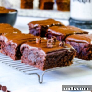 six chocolate brownies on a cooling rack