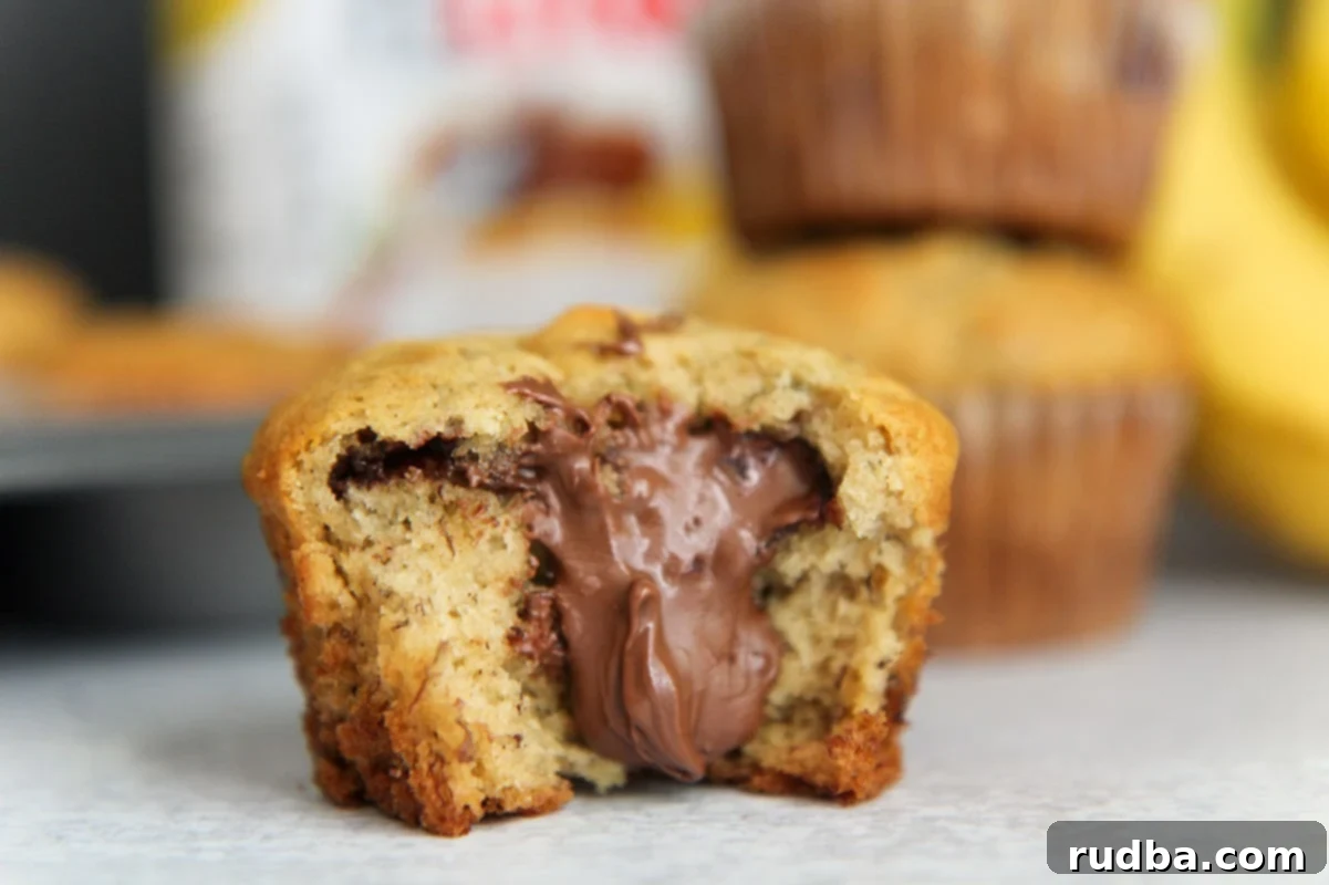 horizontal photo of a muffin up close, showing the golden top and tender texture.