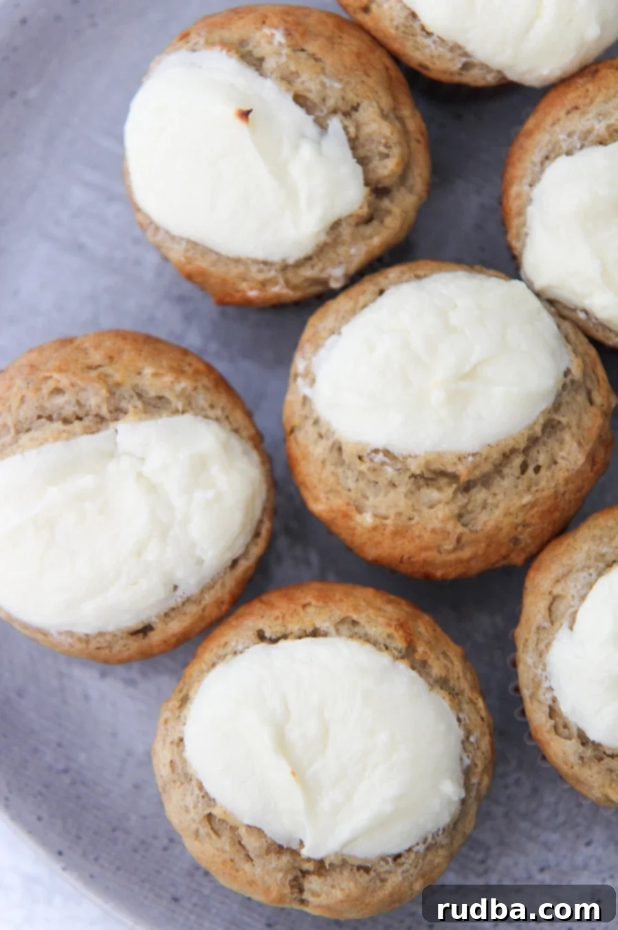 cream cheese banana muffins up close on a gray plate. 