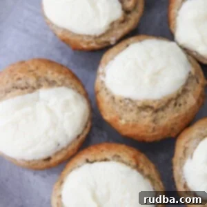 Heavenly Banana Cream Cheese Muffins 4 cream cheese banana muffins up close on a gray plate.