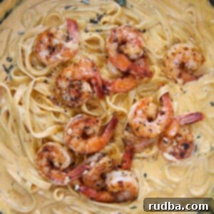 Golden Pumpkin Shrimp Alfredo 4 pumpkin fettuccine alfredo with shrimp in a cast iron skillet.