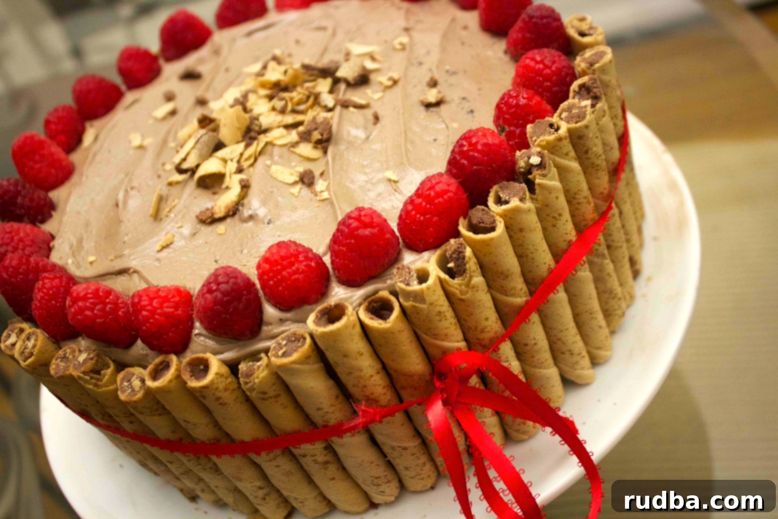 Hazelnut cookie rolls around this Nutella cake give this deliciously moist cake a little extra crunch and elegant finish.