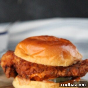 popeye's fried chicken sandwich on a wooden board.