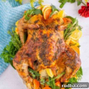 Succulent Oven-Roasted Turkey 6 A beautifully cooked whole turkey on a platter, adorned with orange slices and fresh herbs, ready to be carved.