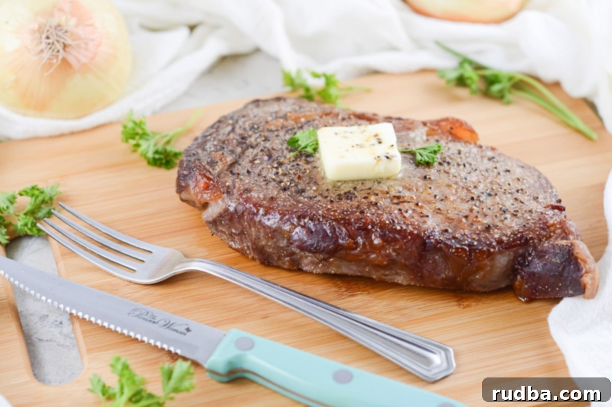 rib eye steak on a wooden board with a fork and knife. 