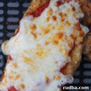 Crispy Air Fryer Chicken Parmesan 5 chicken parmesan in the black air fryer basket.