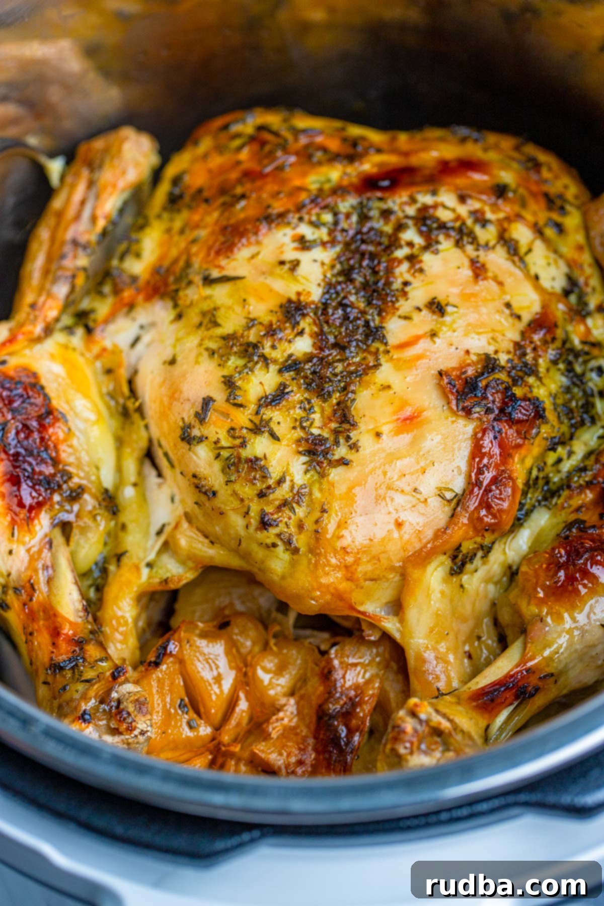 cooked whole chicken in the instant pot up close. Golden brown and juicy.