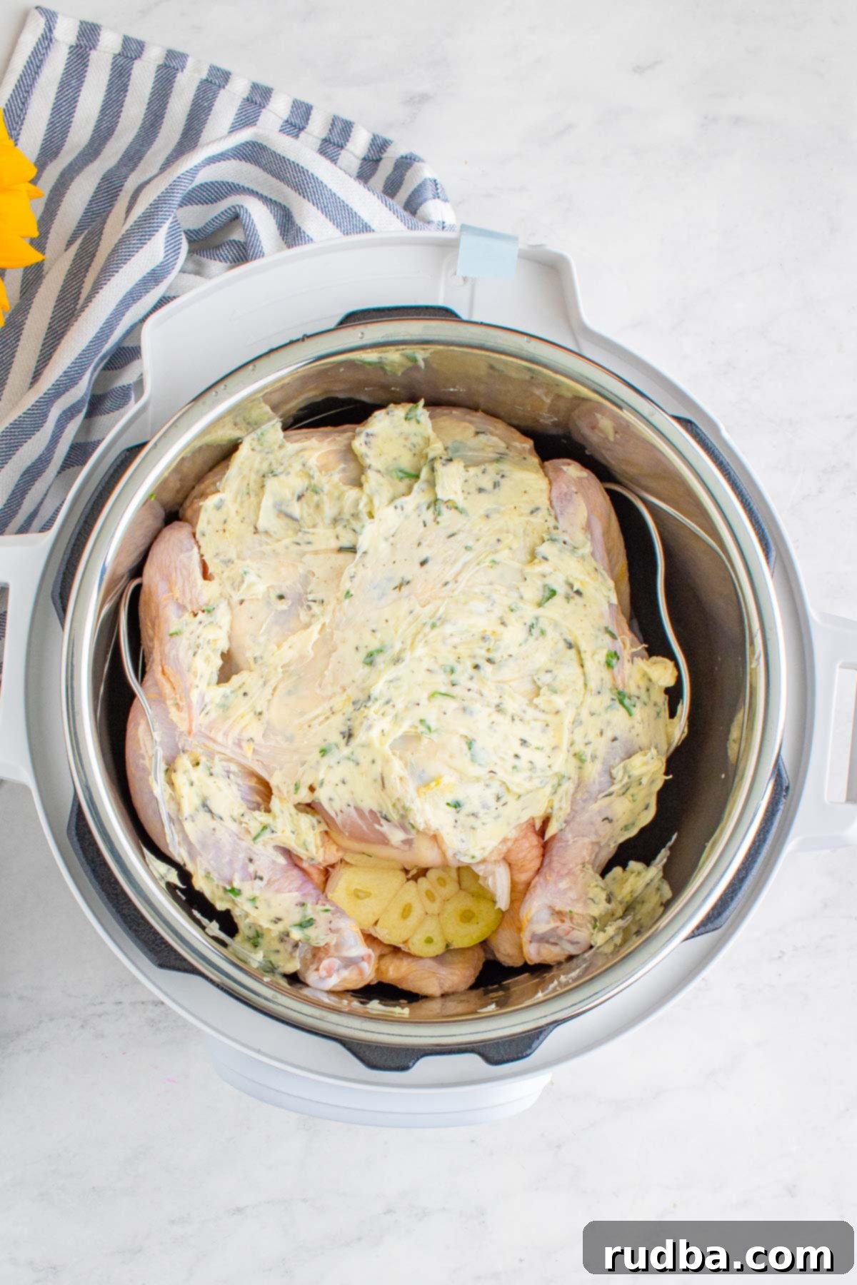 raw chicken with butter and herbs in the pressure cooker. Preparing for cooking.