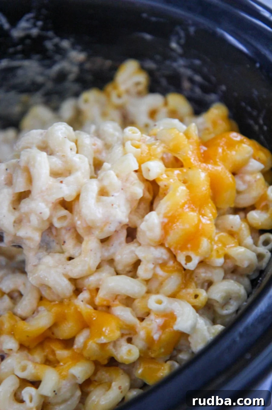 Creamy macaroni and cheese cooked in the slow cooker, close up shot with steam