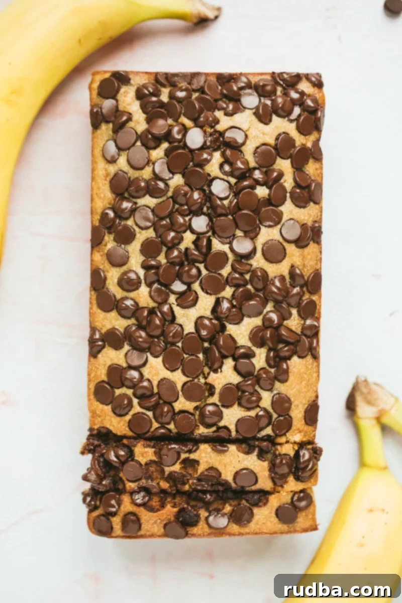 chocolate peanut butter banana bread with two bananas on the side