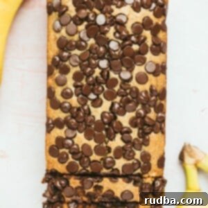 chocolate peanut butter banana bread with two bananas on the side