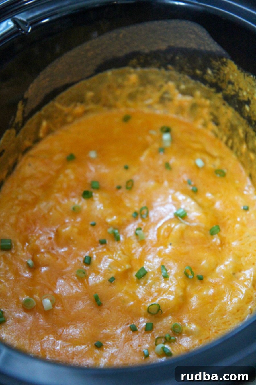 slow cooker buffalo chicken dip in a black crockpot