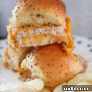 three hot tuna melt sliders with chips on a plate.