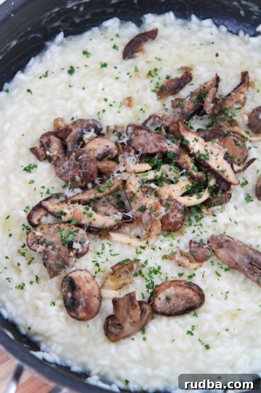 Creamy truffle mushroom risotto, garnished with fresh parsley, served in a bowl, showcasing its rich texture.