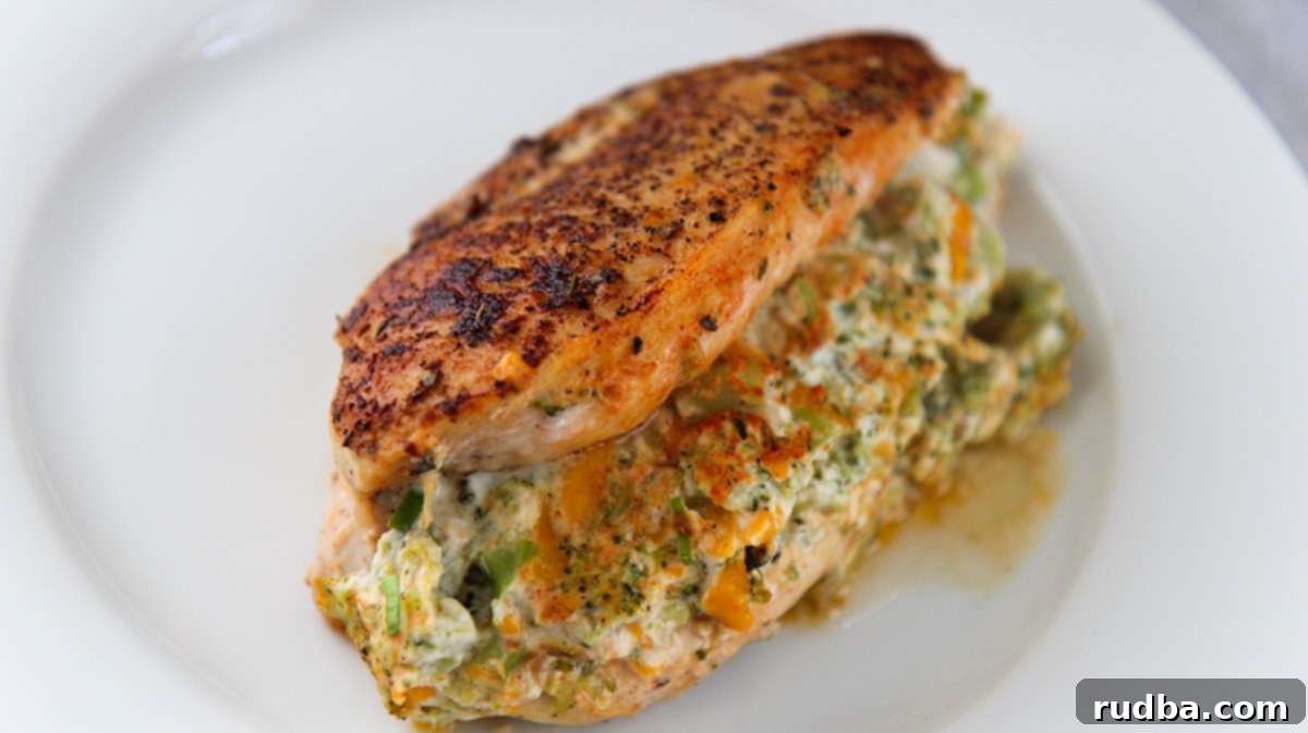 broccoli cheese stuffed chicken on a white plate.