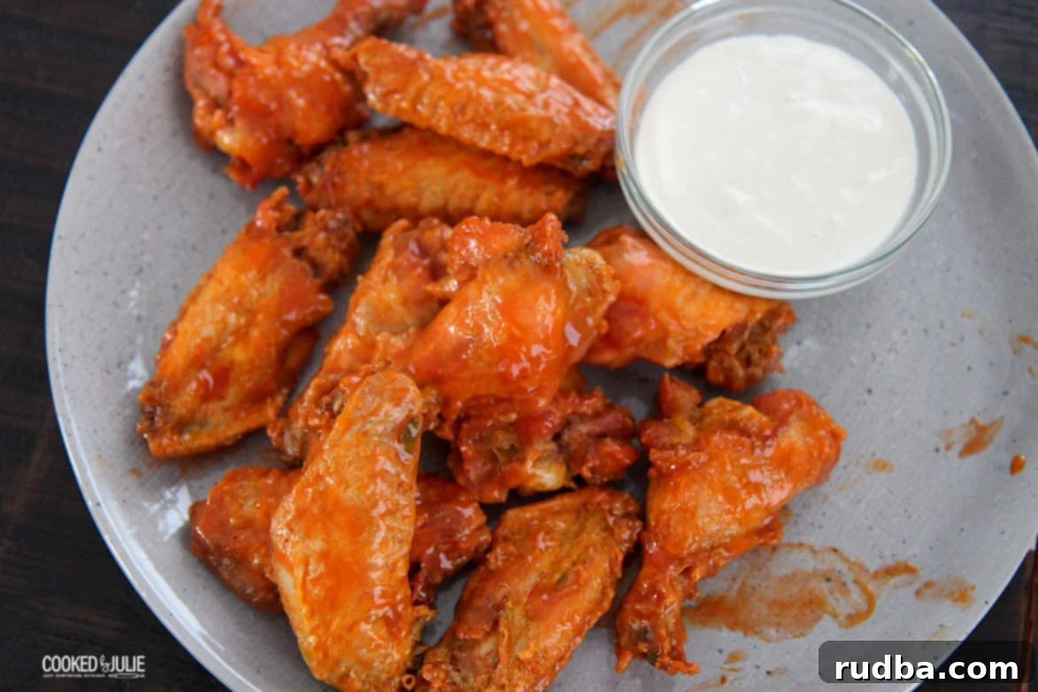 chicken on a gray plate with dip on the side