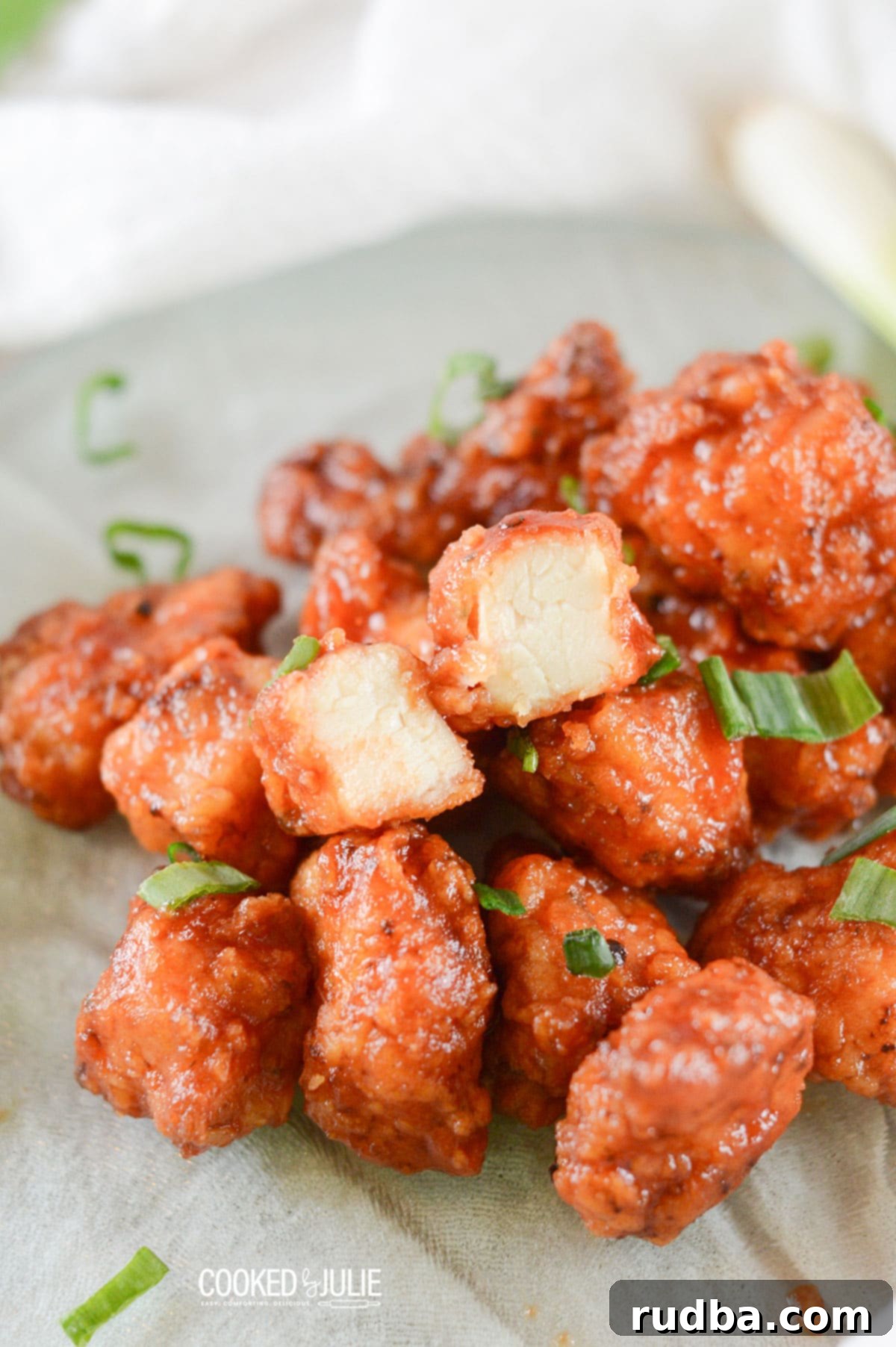 honey boneless bbq wings with scallions on a green plate