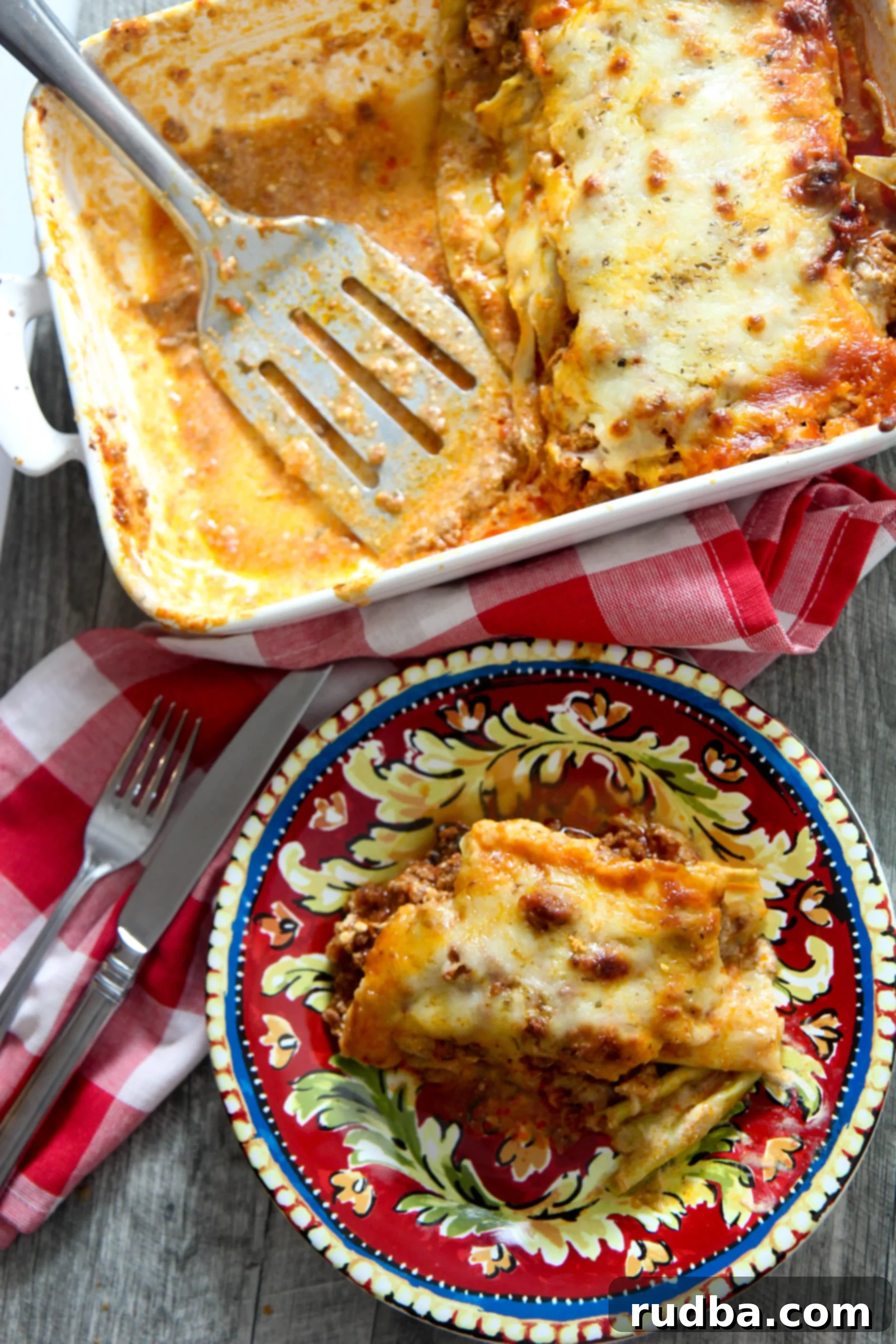 A delicious cabbage lasagna in a baking dish with a single slice on a small plate next to it