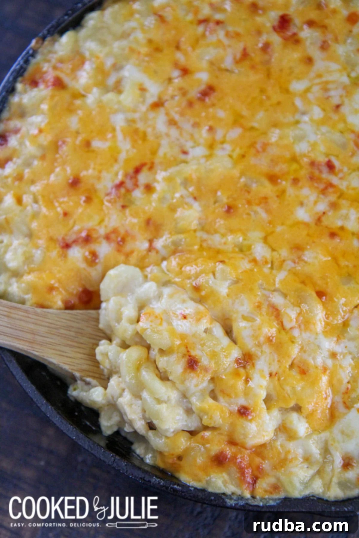 mac and cheese with a wooden spoon