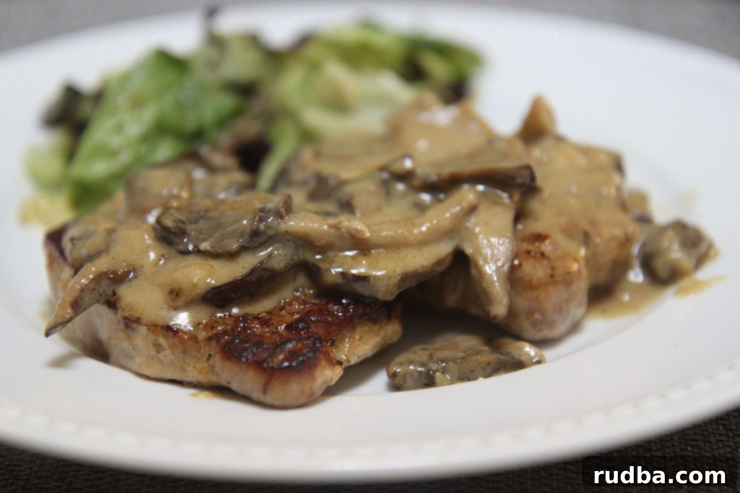 These pork chops are dressed in a creamy garlic sauce with mushrooms and onions.
