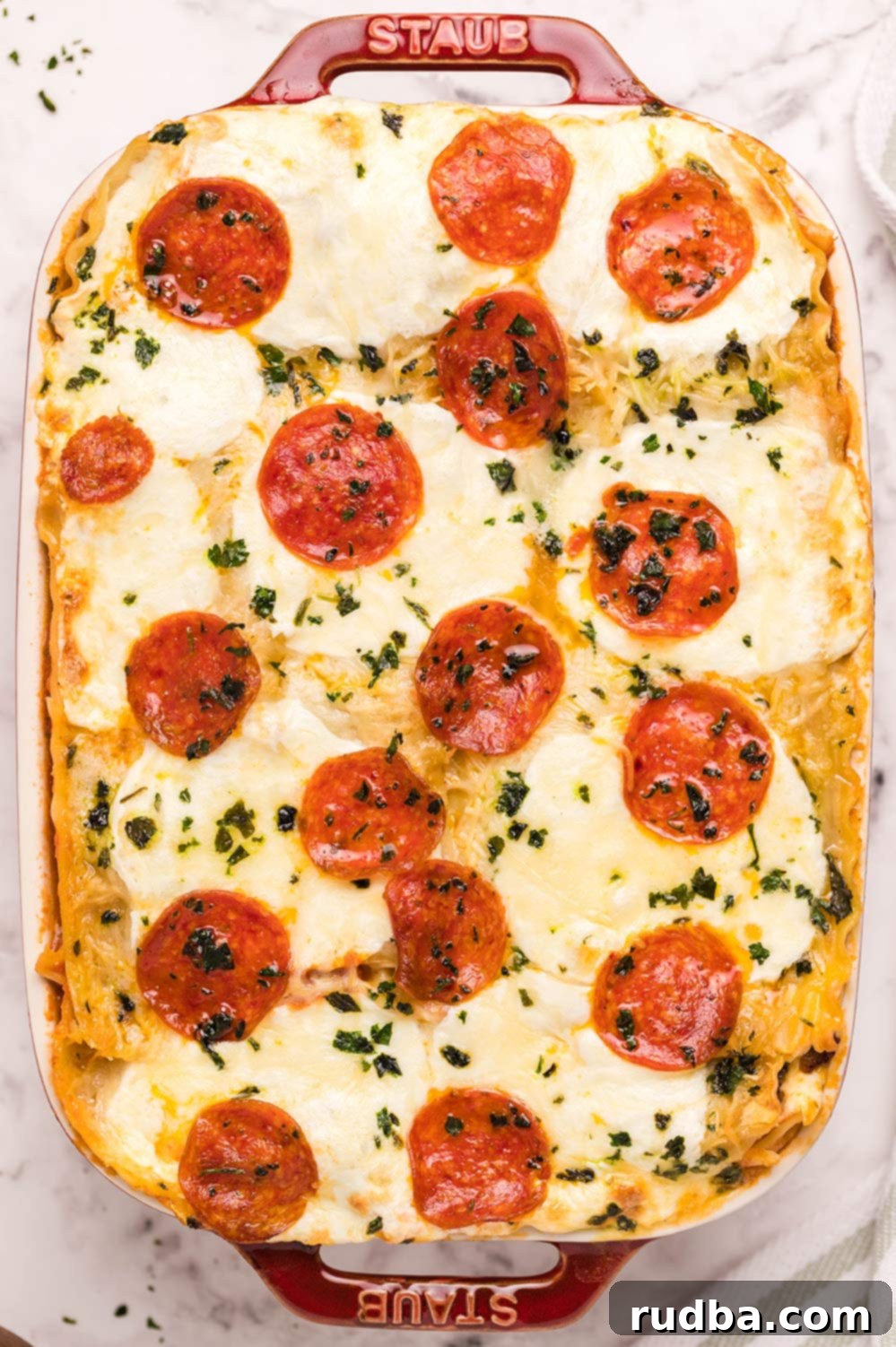 pizza lasagna in a red casserole