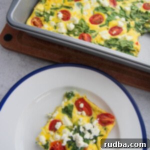 Tangy Goat Cheese and Spinach Egg Bake 4 a slice of spinach and goat cheese frittata on a white and blue plate with a 9x13 frittata in the background.