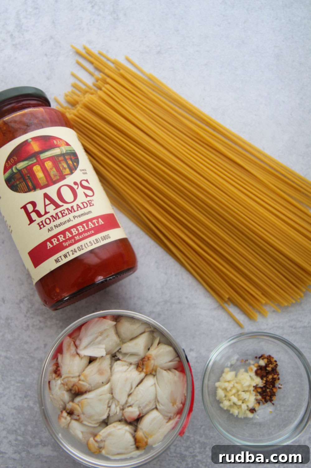sauce in a jar, bucatini pasta, crab meat, and garlic and red crushed pepper in a small bowl. 