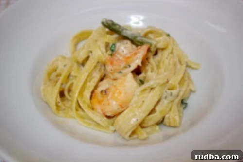 A close-up view of homemade creamy shrimp fettuccine, showcasing the rich sauce and fresh ingredients.