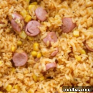 Arroz con Salchichas close up, served in a rustic bowl.