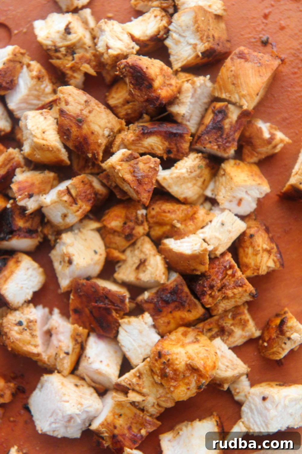 Restaurant Style Chipotle Chicken 3 Diced up chipotle chicken on a wooden board, ready for serving.