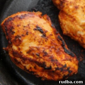 Restaurant Style Chipotle Chicken 5 two chipotle chicken breasts in a cast iron skillet.