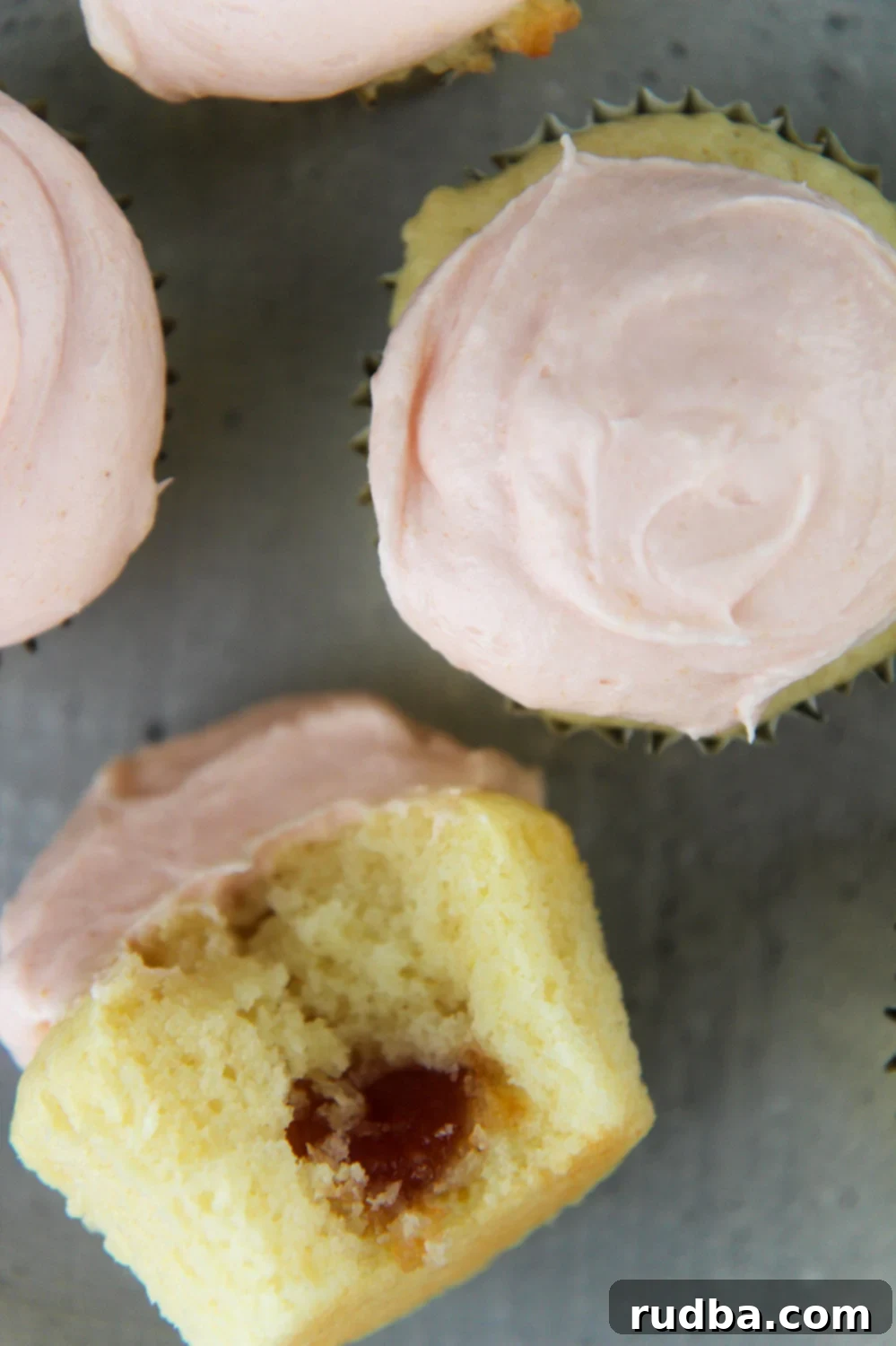 4 guava cupcakes with frosting on top
