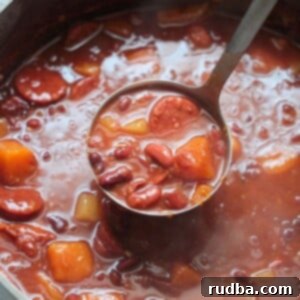 Authentic Cuban Red Beans 2 Cuban red beans in a large pot with a ladle.
