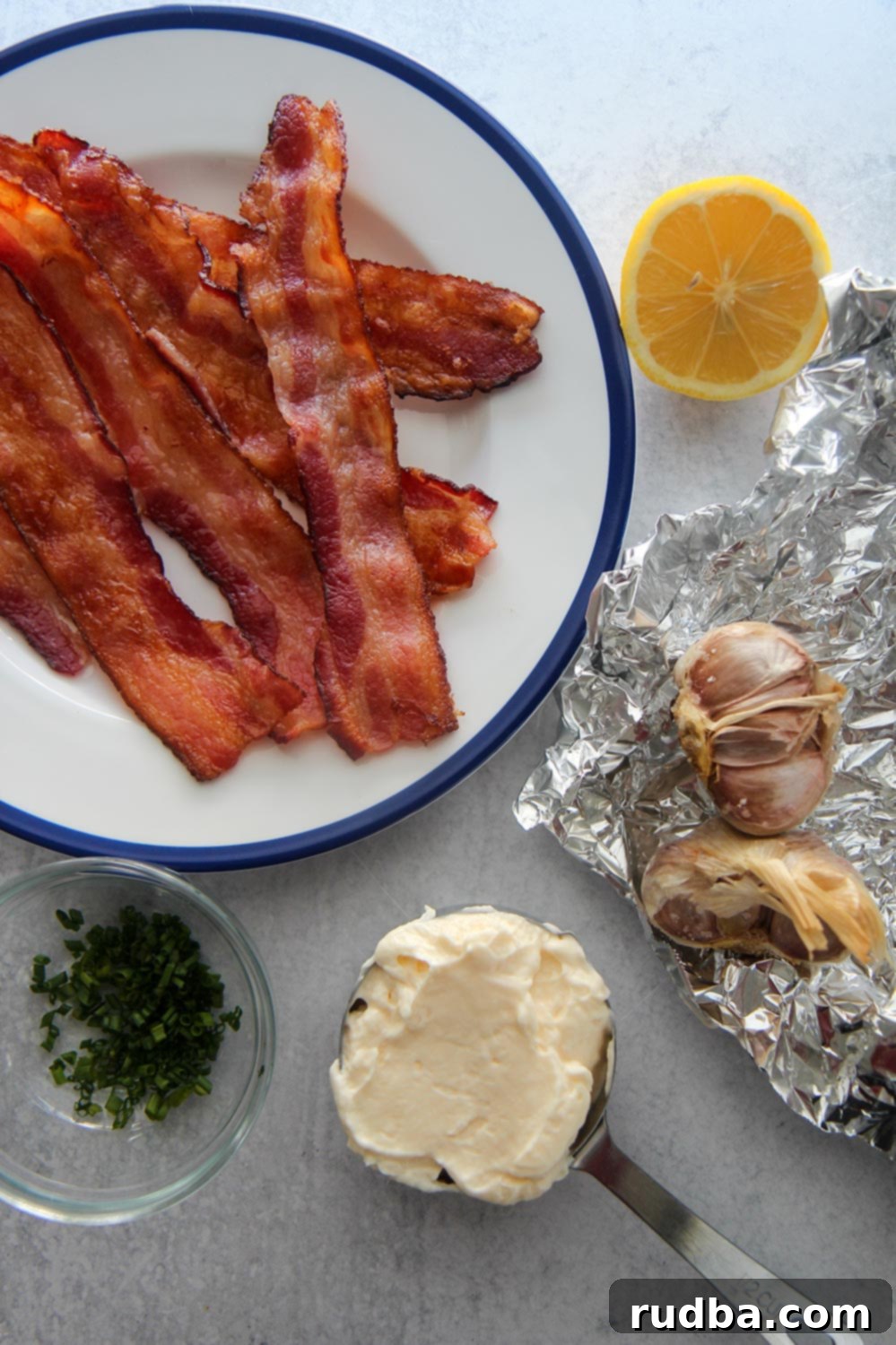 bacon, lemon, chives, mayo, and roasted garlic on aluminum foil.