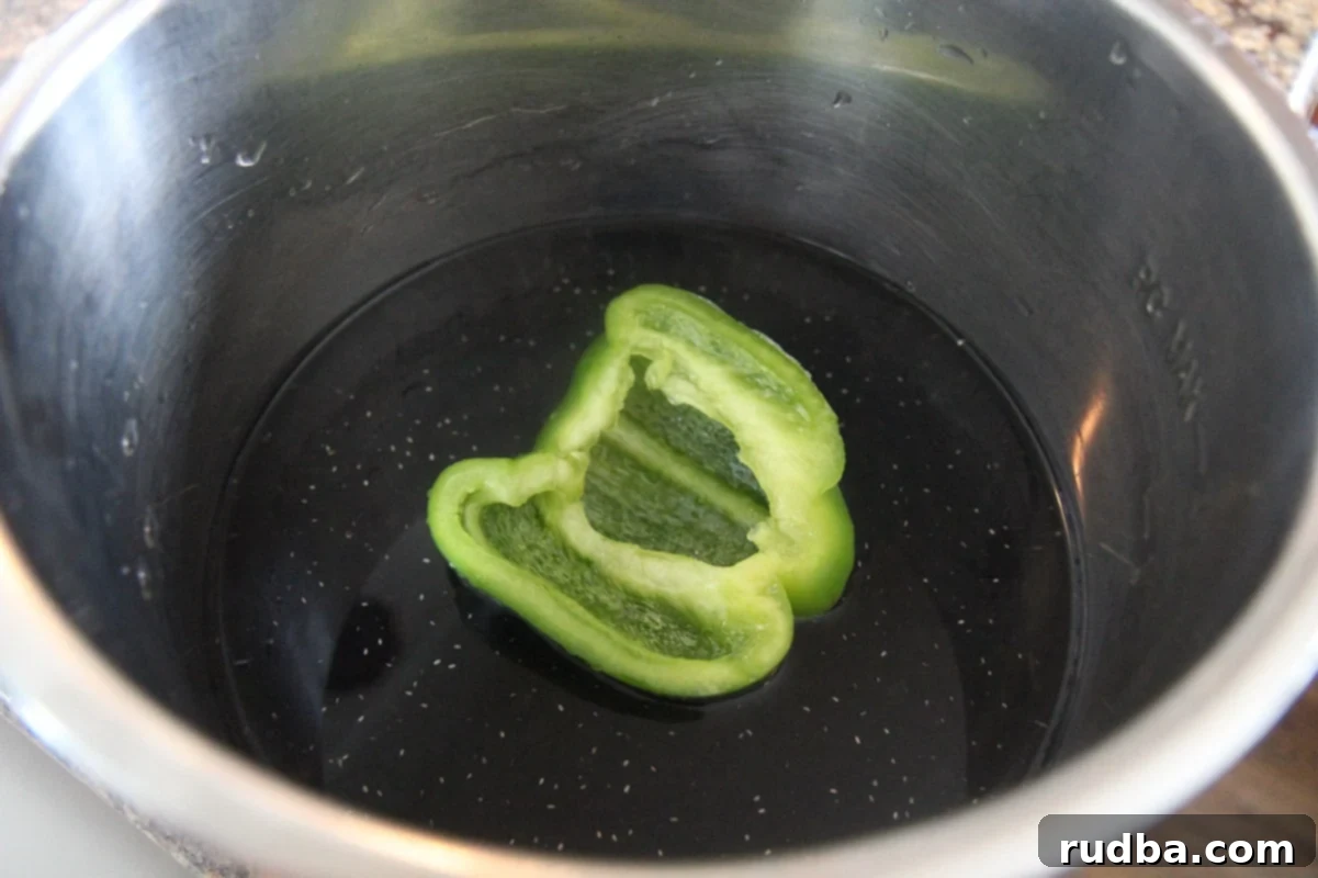 Classic Cuban Black Beans and Rice 4 Black dried beans, water, and a green bell pepper in a pot.